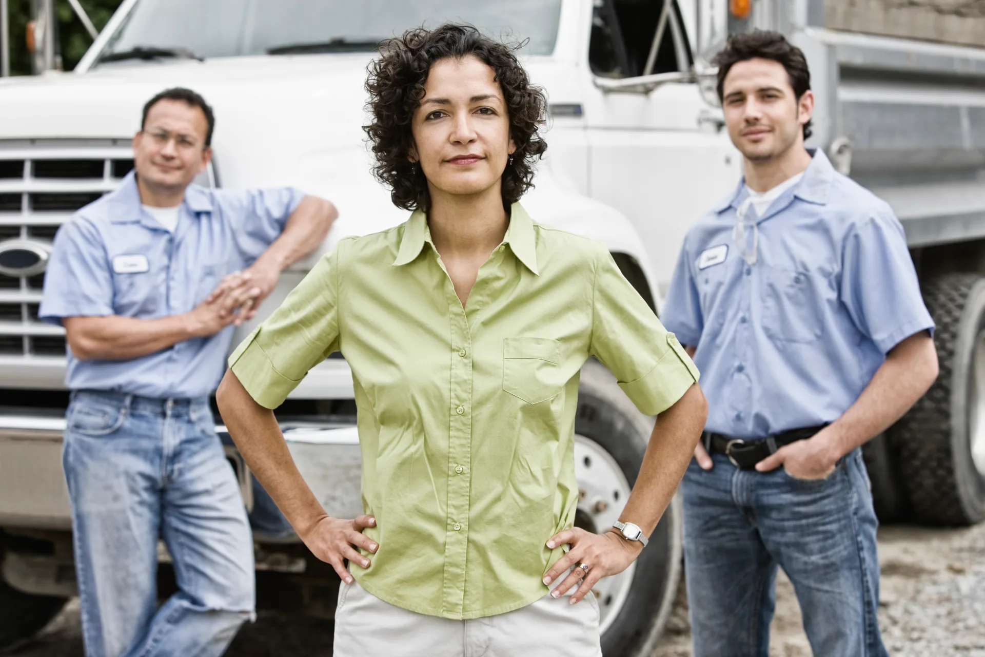 Landscape crew standing together in front of a work truck