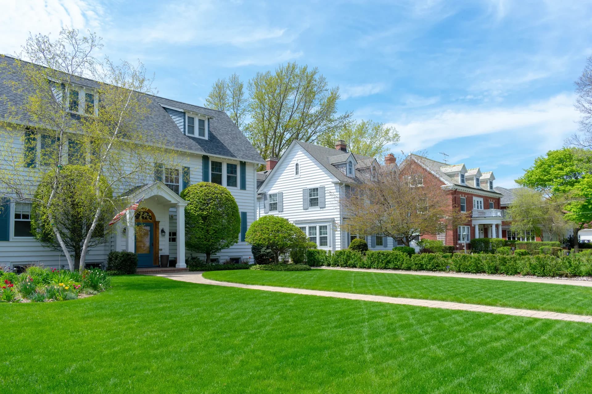Suburban homes with lush green front lawns
