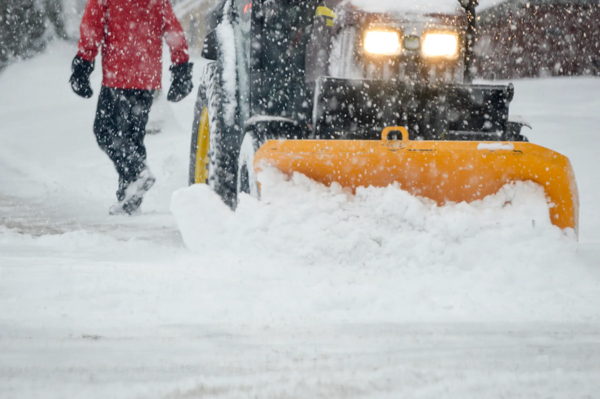 Tractor plowing snow after a winter storm